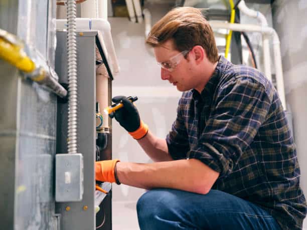 Technician Repairing a furnace.